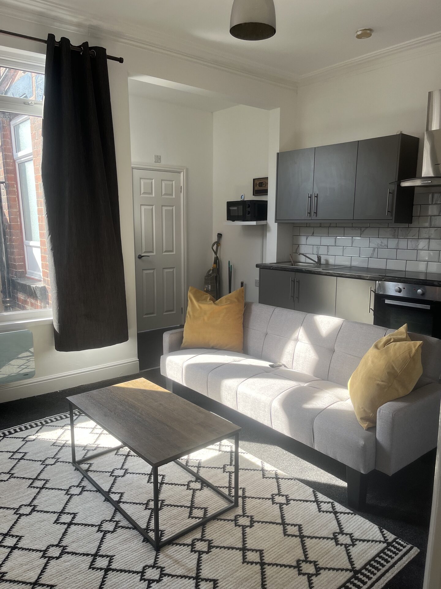 Open-plan lounge with kitchen behind at The Aberdeen House, Floor 1