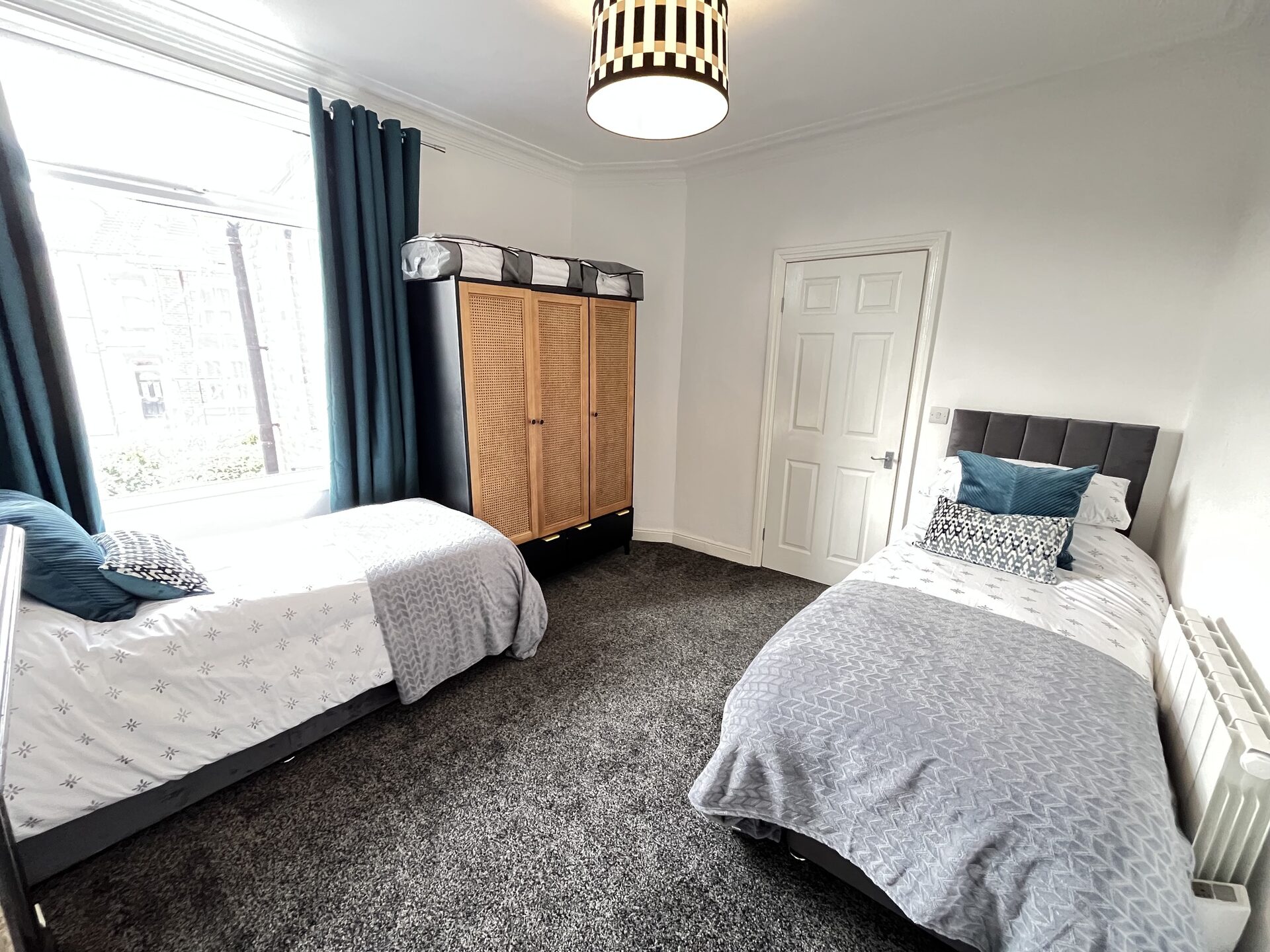 Twin bedroom — rattan wardrobe by the bay window at The Aberdeen House, Floor 2