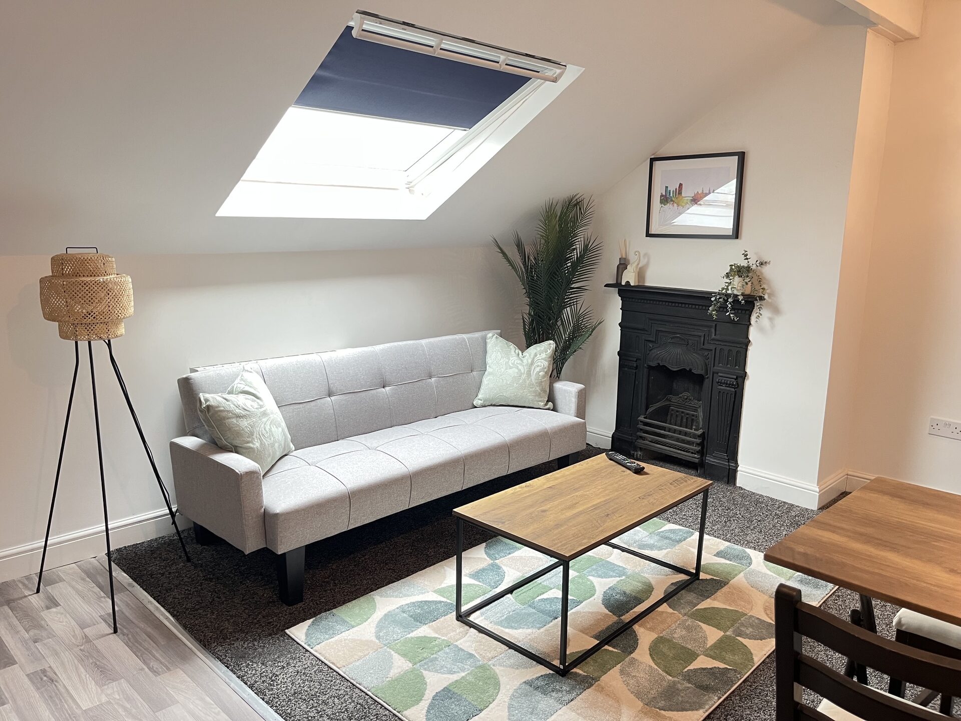 Floor 3 attic lounge with cast-iron fireplace and velux skylight at The Aberdeen House
