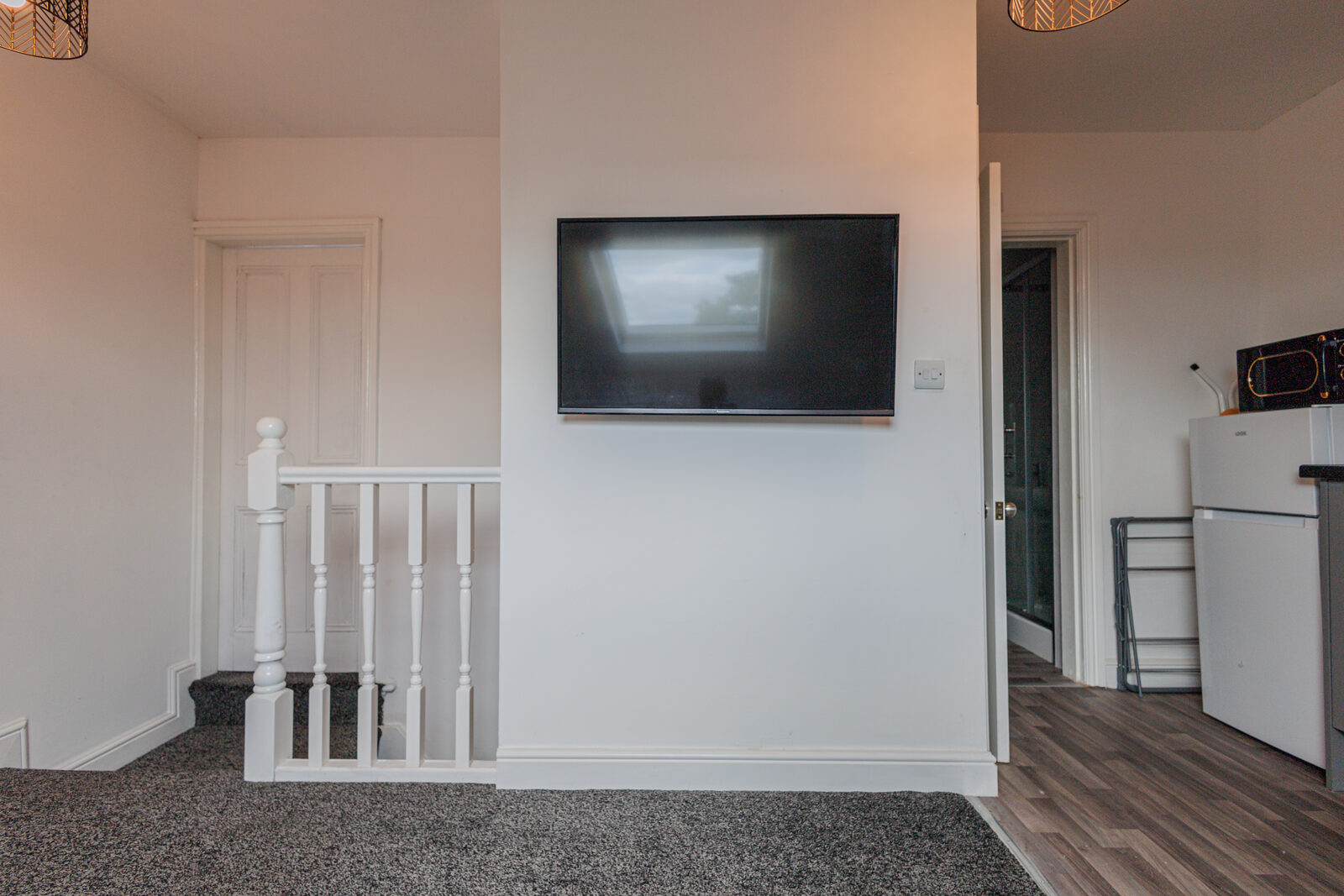 Top-floor landing — TV and stairs at The Aberdeen House, Floor 3